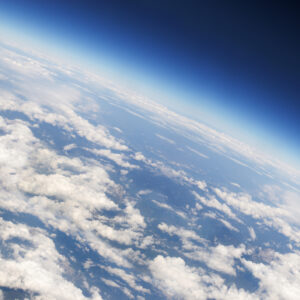 a view of Earth's atmosphere from above, with plenty of scattered clouds.