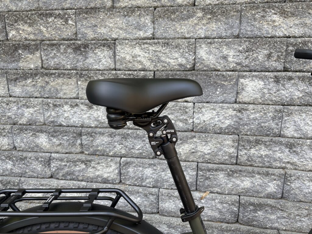 Image of the saddle of a bicycle, showing a mechanical dampener between it and the seat post.