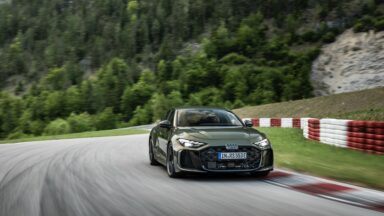 A green Audi RS5 on track