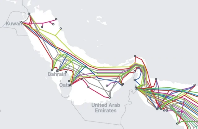 Multi-colored lines running through a map representing the Strait of Hormuz show undersea Internet cable routes.