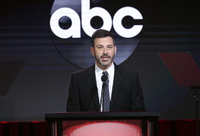 Jimmy Kimmel speaking on stage at an event with an ABC logo in the background.