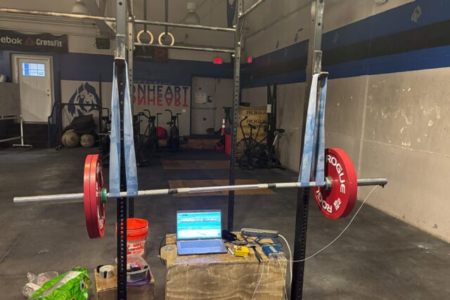 The experimental setup used to determine the vibrations of barbells used in Olympic weightlifting.