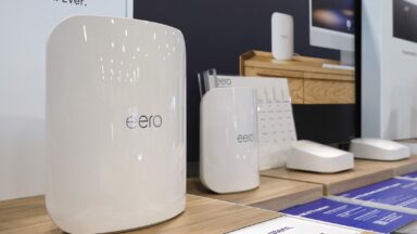 Eero Wi-Fi routers on display inside a store in front of an advertisement that says, "Our most advanced Wi-Fi system, ever."