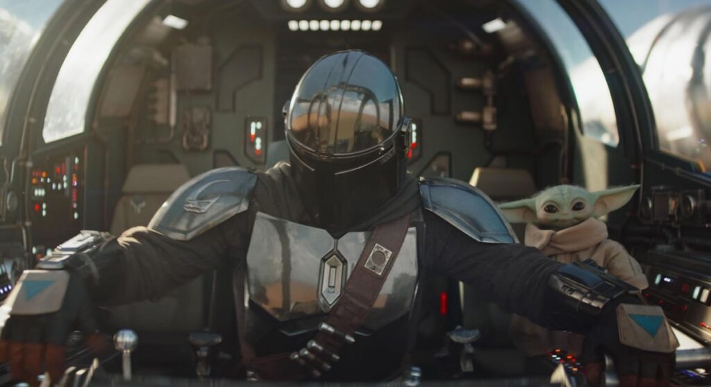 figure in full Mandalorian armor piloting a spaceship with little green figure off to the side