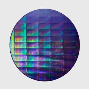 Image of a circular wafer with a grid of rectangular devices etched into it.