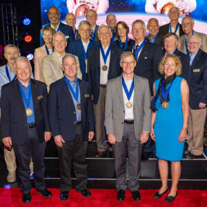 Twenty men and women pose together as members of the same Hall of Fame.
