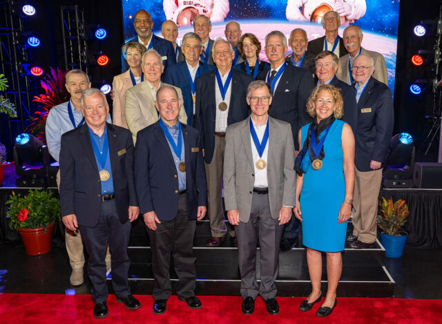 Twenty men and women pose together as members of the same Hall of Fame.