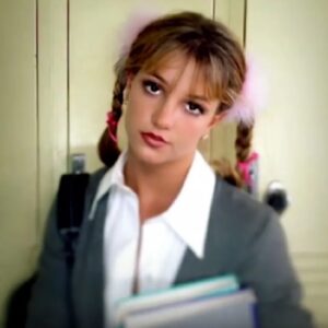 young schoolgirl in pigtails staring into the camera with head slightly tilted