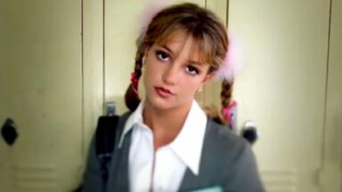 young schoolgirl in pigtails staring into the camera with head slightly tilted