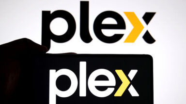In this photo illustration, a Plex logo is seen displayed on a smartphone and in the background.
