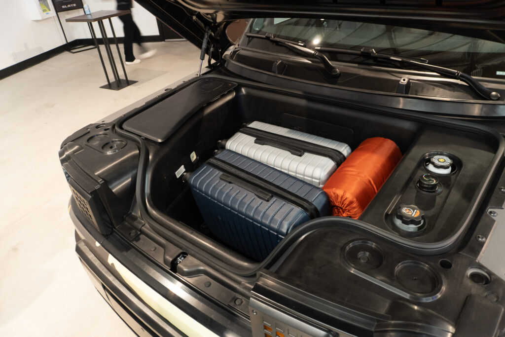Slate truck frunk with luggage in it.