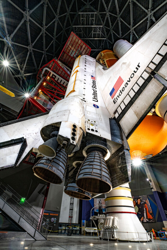 an indoor space shuttle museum display is seen from the floor level looking up