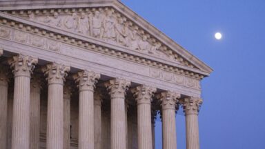 Exterior view of Supreme Court building and its marble columns.