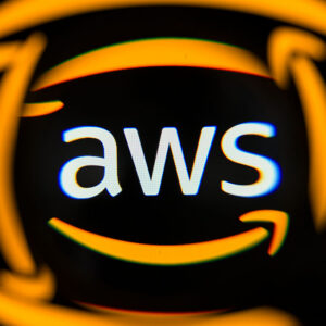 The AWS logo is displayed on a computer screen photographed through a magnifying glass in Creteil, France, on May 4, 2026.