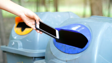 Woman throwing a phone into the trash