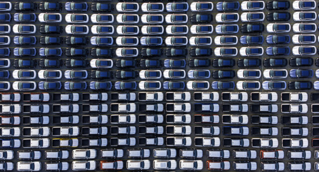 Image of vast rows of vehicles parked for storage.