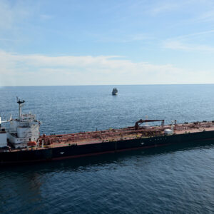 This aerial picture taken on October 1, 2025 off the coast of the western France port of Saint-Nazaire shows the tanker Boracay from Russia's so-called "shadow fleet" suspected of being involved in drone flights over Denmark which sailed off the Danish coast between September 22 and 25, with a boat of the French Navy in the background.
