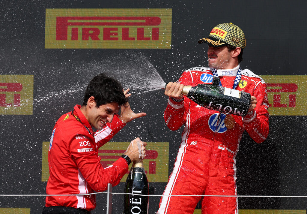 NORTHAMPTON, ENGLAND - JULY 05: Race winner Charles Leclerc of Monaco and Scuderia Ferrari and Bryan Bozzi, Race Engineer of Scuderia Ferrari celebrate on the podium with Champagne during the F1 Grand Prix of Great Britain at Silverstone Circuit on July 05, 2026 in Northampton, England. (Photo by Clive Mason/Getty Images)