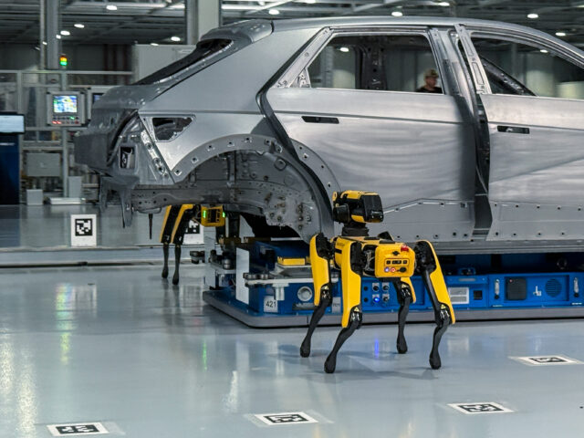 A pair of Boston Dynamics robots inspect a Hyundai Ioniq 5 body shell at the HMG Metaplant outside Savannah, GA.