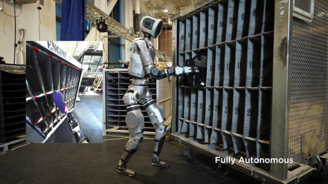 An Atlas humanoid robot from Boston Dynamics autonomously moves engine covers between supplier containers and a mobile sequencing dolly in a lab experiment.