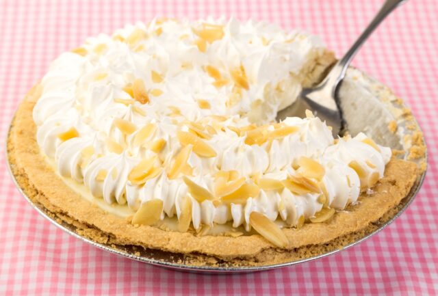 A banana cream pie with a fork sticking out of it