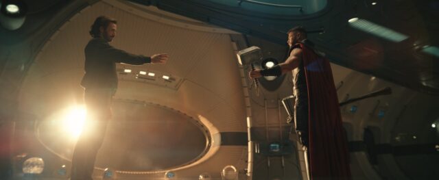 bearded Steve Rogers holds out his hand to accept Thor's proffered hammer
