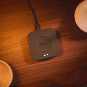 Aerial view of a Hue Bridge Pro that's on a table and powered on.