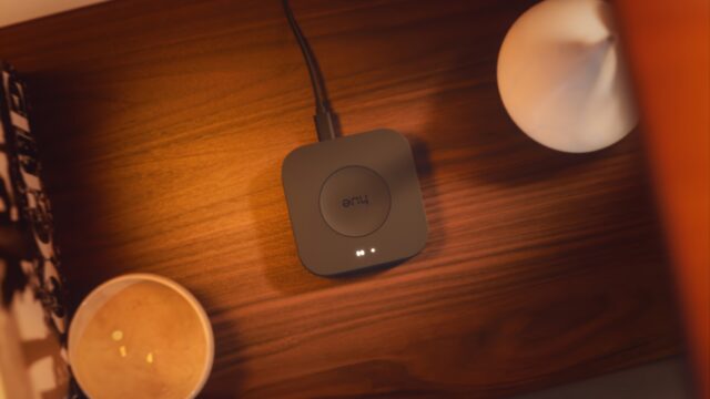 Aerial view of a Hue Bridge Pro that is on a table and powered on.