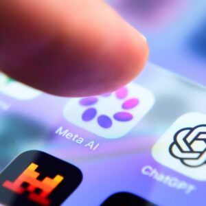 A person's finger hovers over a smartphone app icon for the Meta AI app