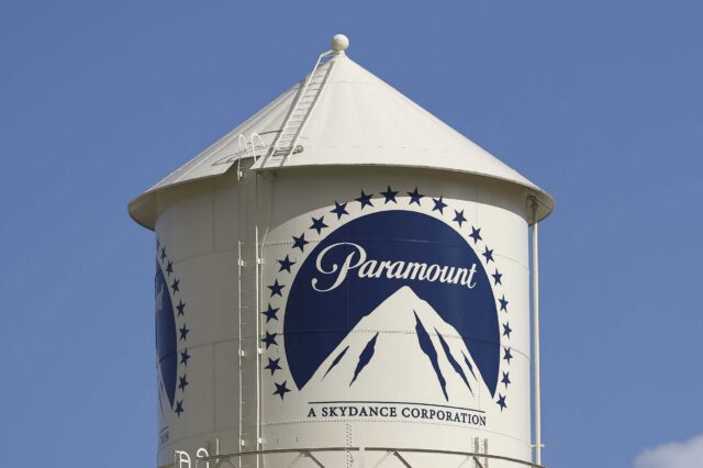 A water tower with the Paramount logo painted on its side.