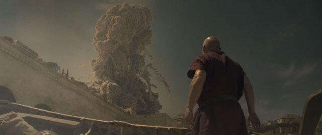 The Praetorian, played by Barry Aird, stands on the beach looking up in horror as the eruption column from Vesuvius towers into the sky over the city walls of Herculaneum.