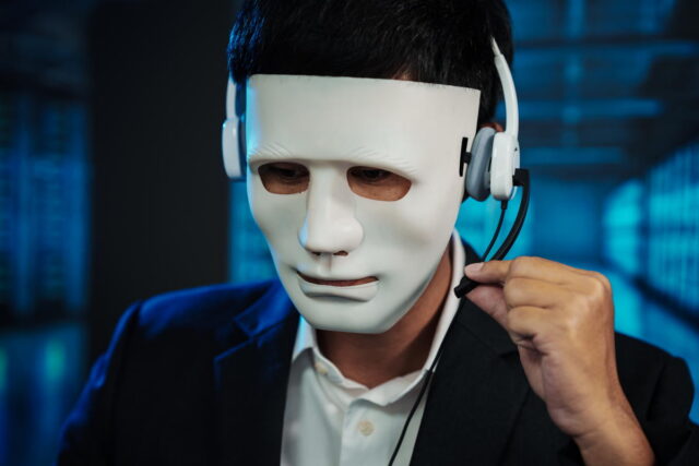 Businessman wearing white mask and headset, adjusting microphone in dark blue office
