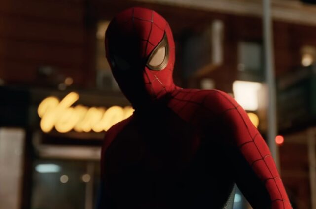 closeup of spiderman on a city street at night