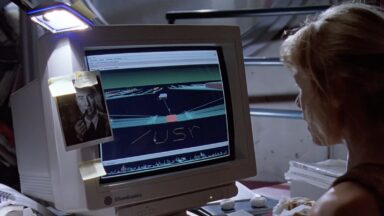 A still from Jurassic Park, showing a young woman sitting at an SGI workstation