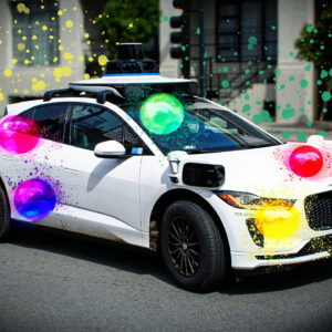 A Waymo covered in balloons