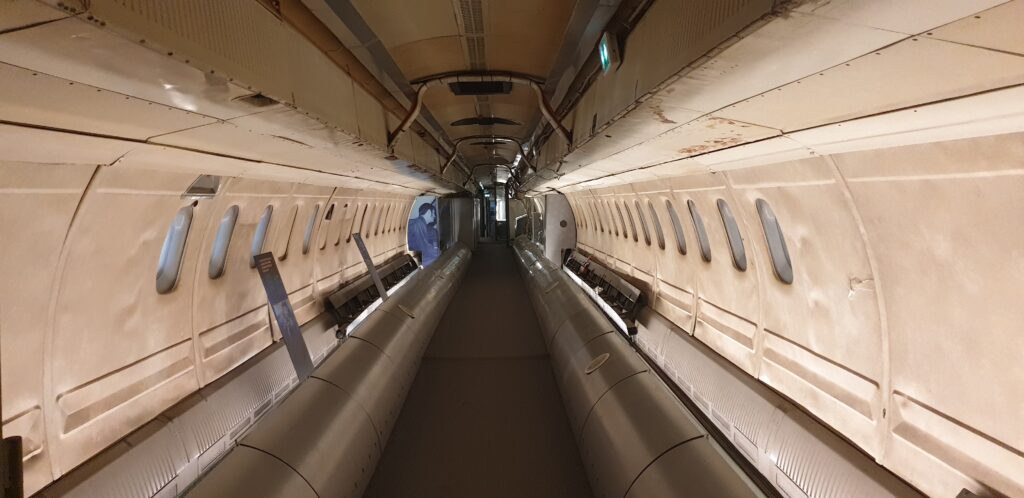 Image of the inside of a narrow aircraft, with no seating visible.