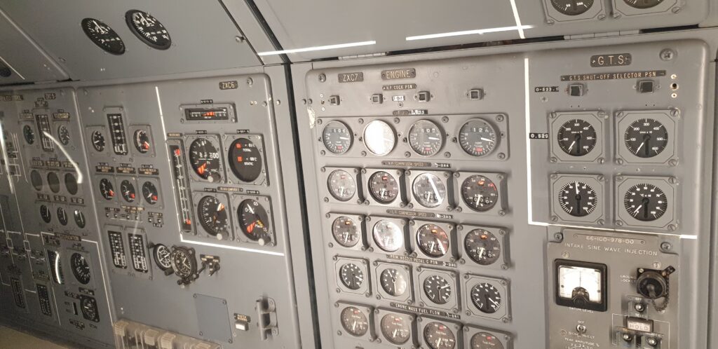 Image of a grey metal panel studded with dials and displays.