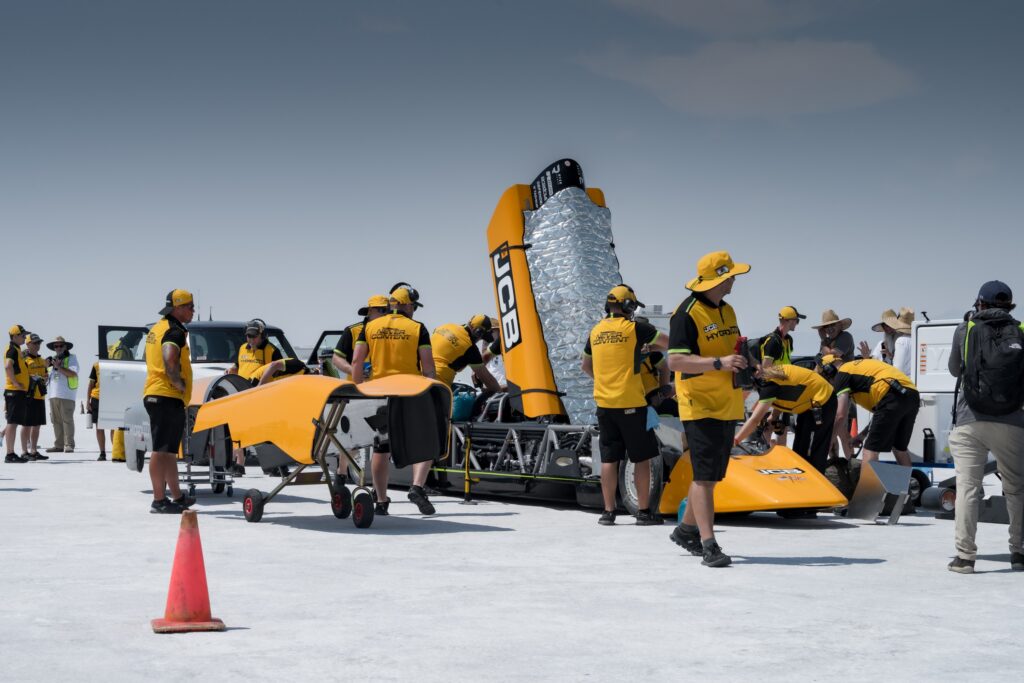 People work on a land speed car.