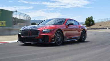 A red and black Bentley on track at Laguna Seca