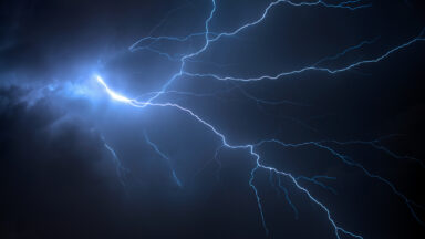 Image of a branched lightning bolt against a dark sky.