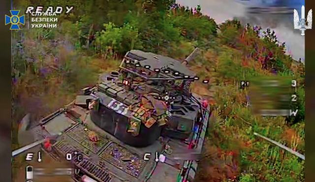 A screencap from a video posed by the Security Service of Ukraine shows the first-person view of a Ukrainian drone about to strike the rear of a Russian tank. The tank is apparently equipped with a new Arena-M active protection system intended to shoot down incoming drones and other munitions.
