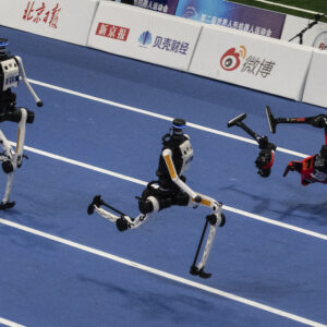 An Honor humanoid robot breaks into pieces as it runs next to two Tian Gong Ultras, center and left, in the second heat of the large robot category of the 100 meter at the 2nd World Robot Games at National Speed Skating Oval on August 25, 2026 in Beijing, China.