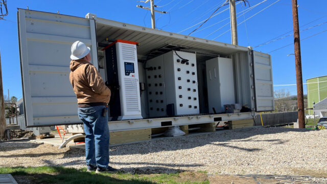 NC State's 1 MW solid-state transformer system during deployment for field testing on a live distribution feeder at EPRI's Lenox, Mass., test site. The shipping container houses, from left to right, the charger enclosure, the SST enclosure, and the breaker box enclosure.