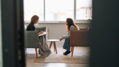 Young woman talking to psychologist in the office