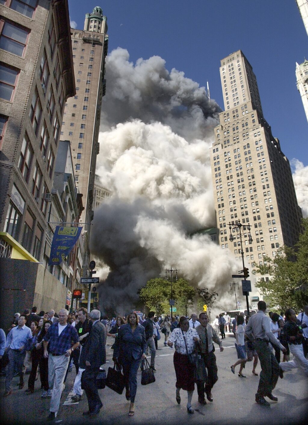 People flee the falling South Tower of the World Trade Center on September 11, 2001