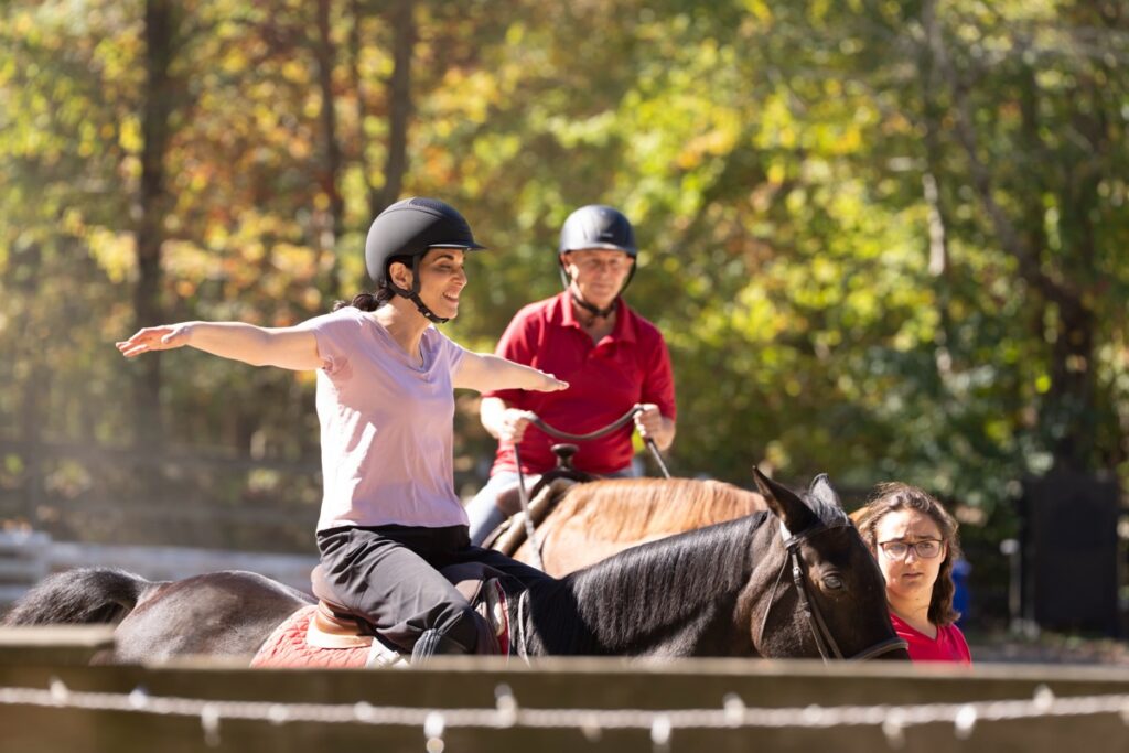 Debbie St. John and Stefan Horlacher ride horses together