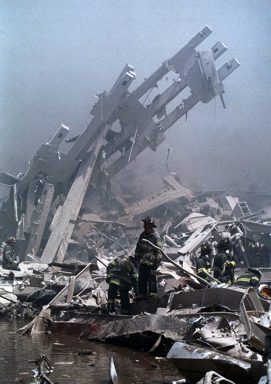 Firefighters navigate the rubble of the World Trade Center on September 11, 2001