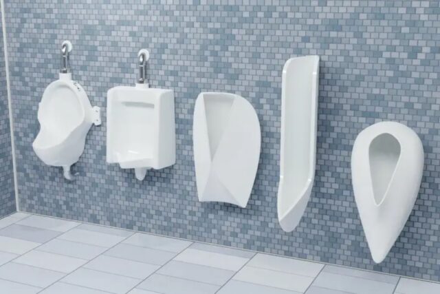 line of urinals of varying shapes mounted on a tiled bathroom wall