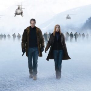 man and red-haired woman walking across a snowy surface with helicopters hovering in the background. A blood-red X stains the snow