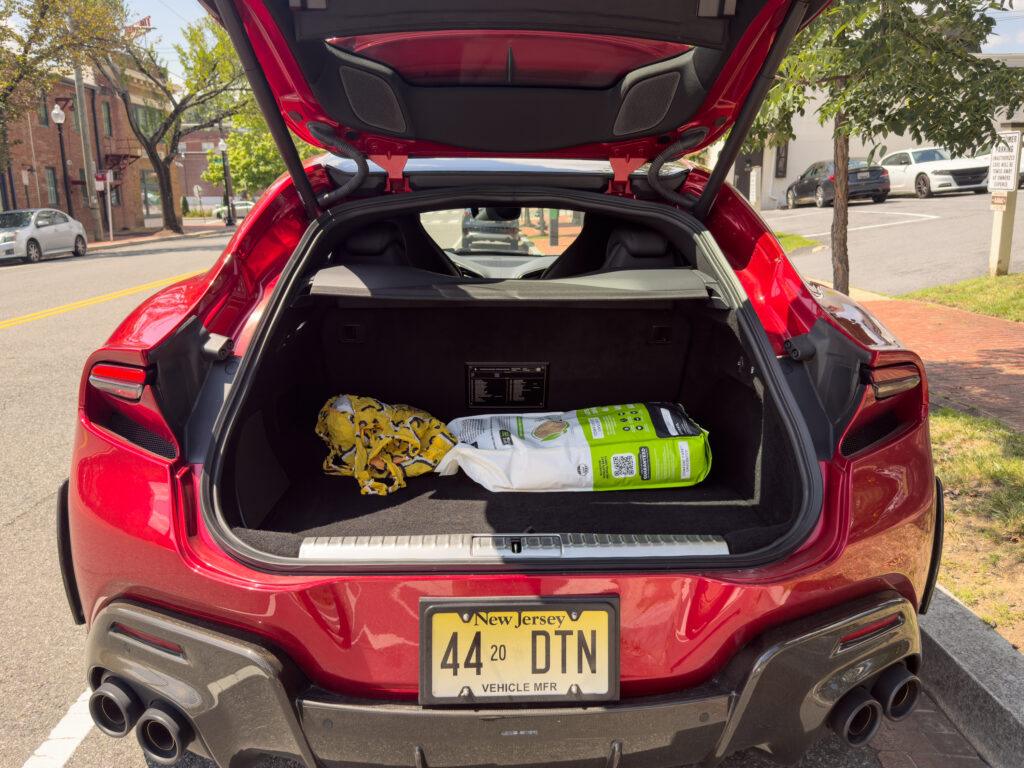 Ferrari Purosangue cargo area with a bag of cat litter in it.